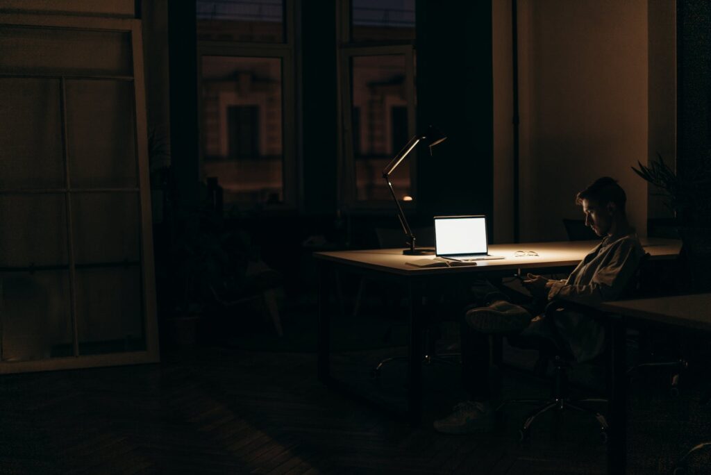 silver macbook on brown wooden table